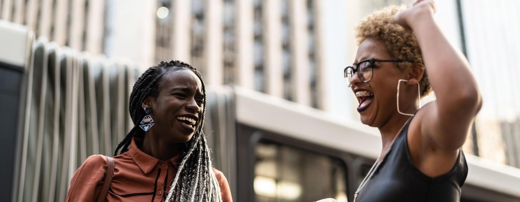 women laughing together in the city
