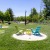 a group of chairs in a grassy area