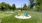 a group of chairs in a grassy area