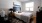 a bedroom with a bed and a fan