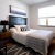 a bedroom with a bed and a fan