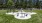 a large grassy area with a playground in the background